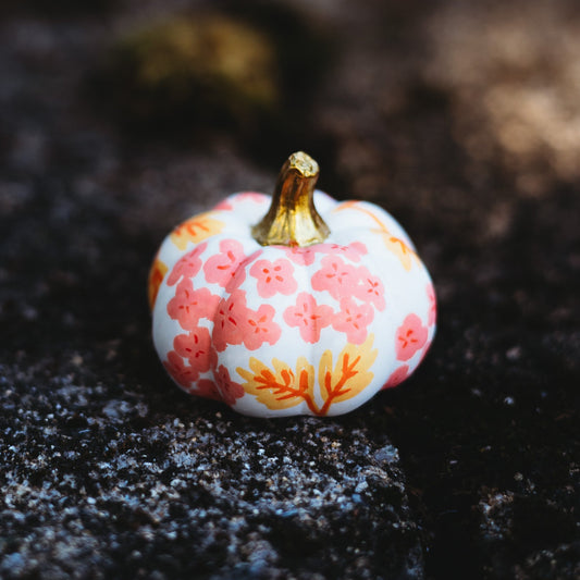 Decorative pumpkin with floral pattern on a dark surface