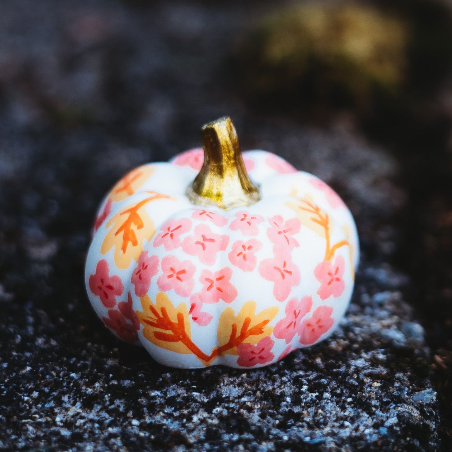 Decorative pumpkin with floral pattern on a dark surface