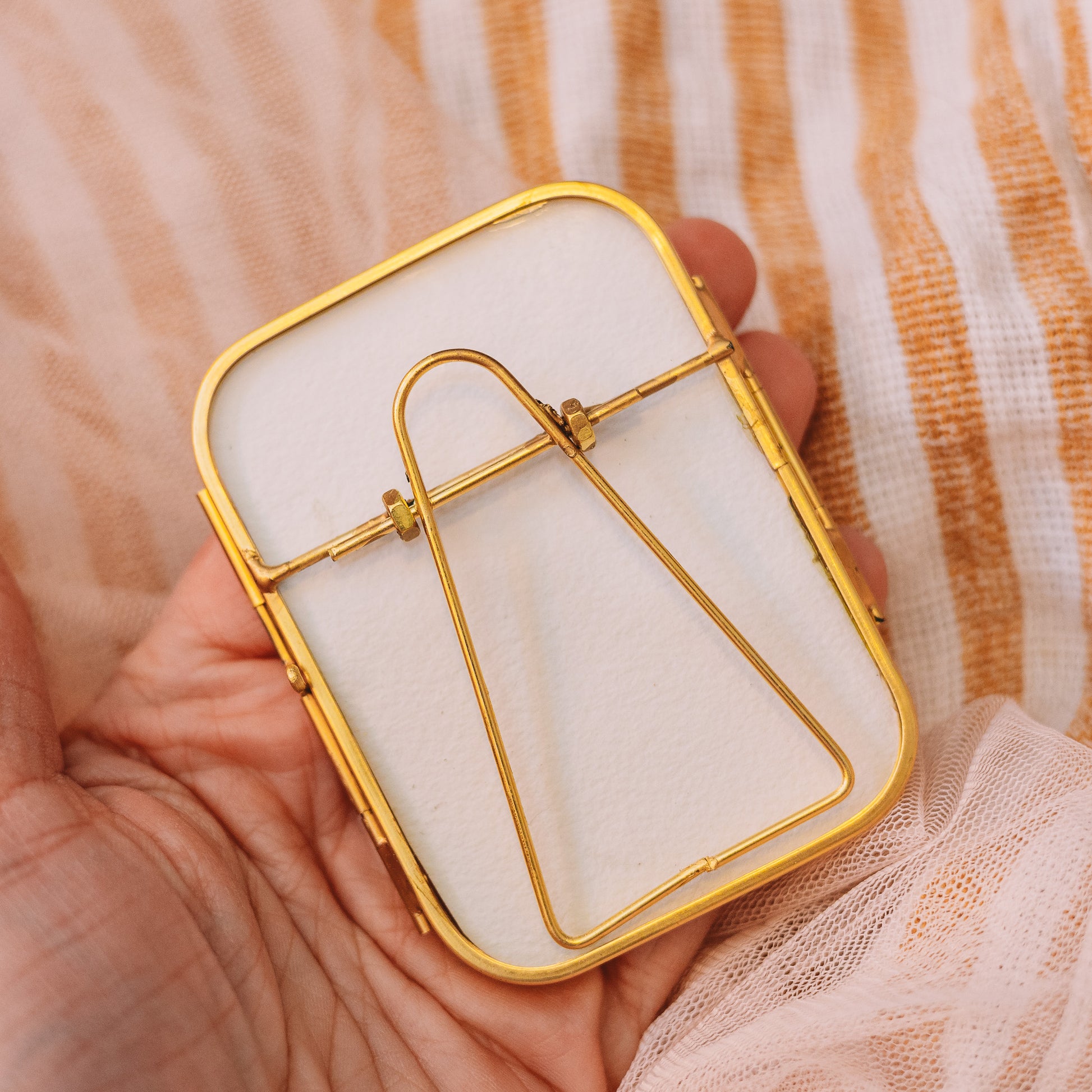 Decorative gold frame in hand